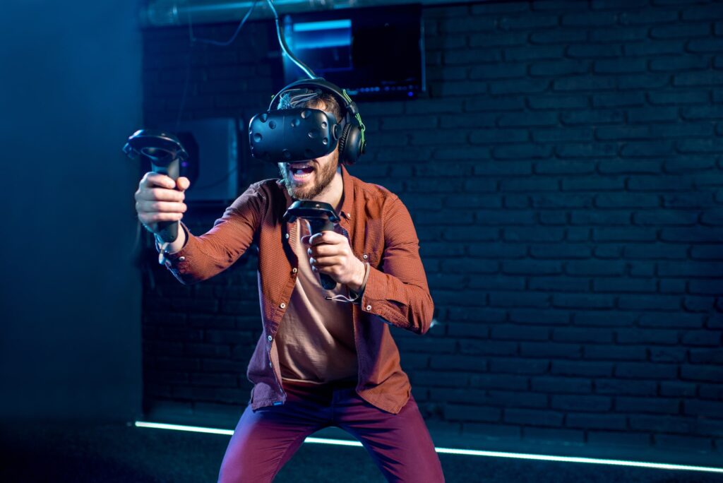 Man playing game with virtual reality headset in the club